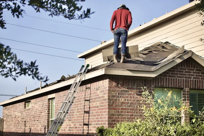Professional roofer working on a residential roof in Foothills Golf Club